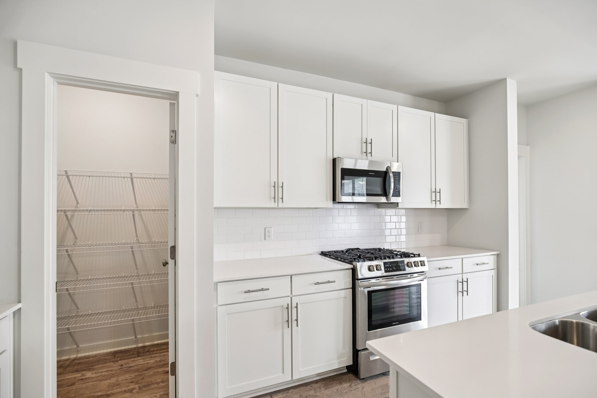 403 Wind Dance Drive Lebanon, TN 37087 - Photo 10 of 66 a kitchen with white cabinets and white appliances