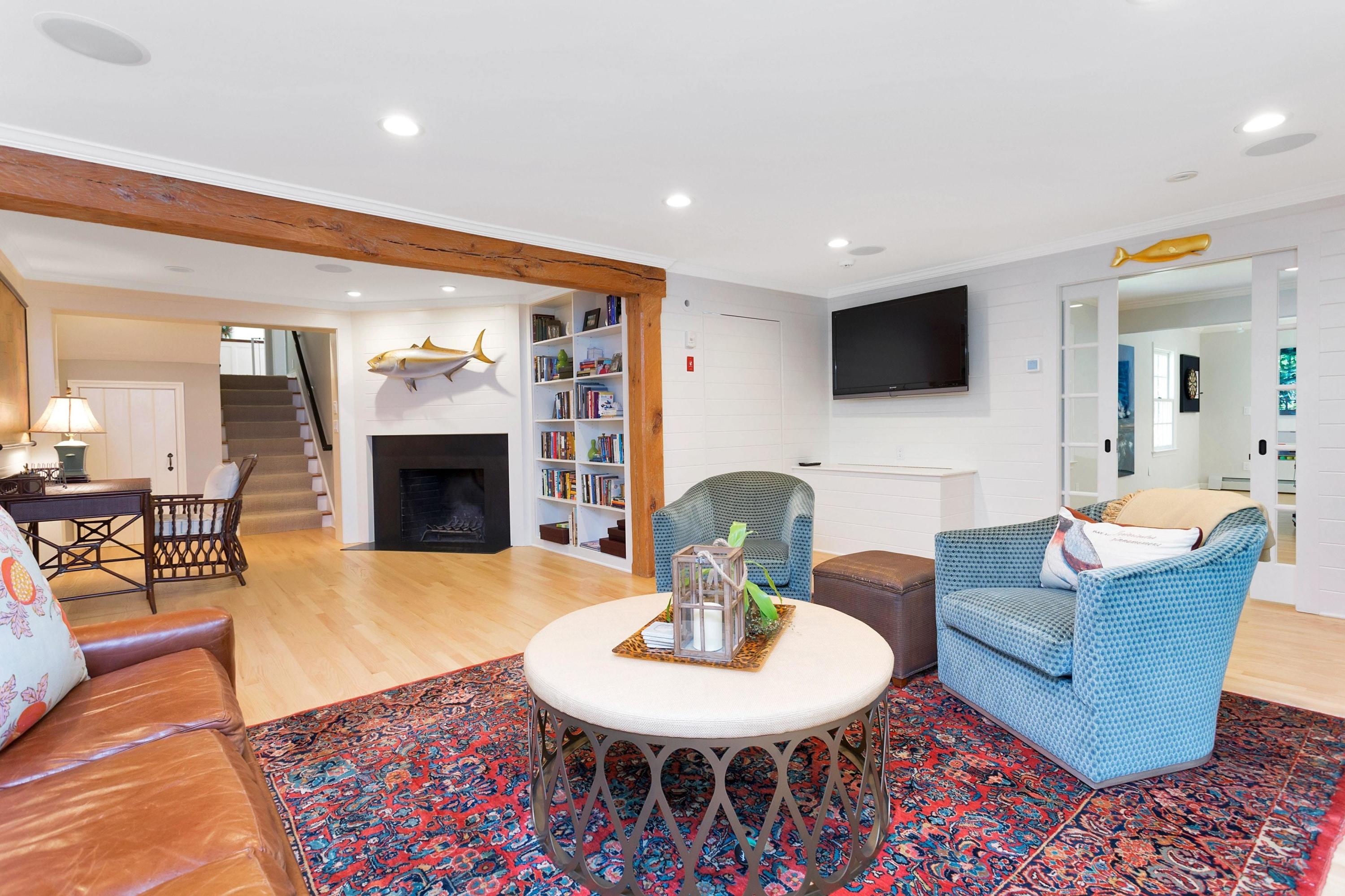44 Deepwood Road Darien, CT 06820 - Photo 15 of 45 a living room with furniture a fireplace and a flat screen tv