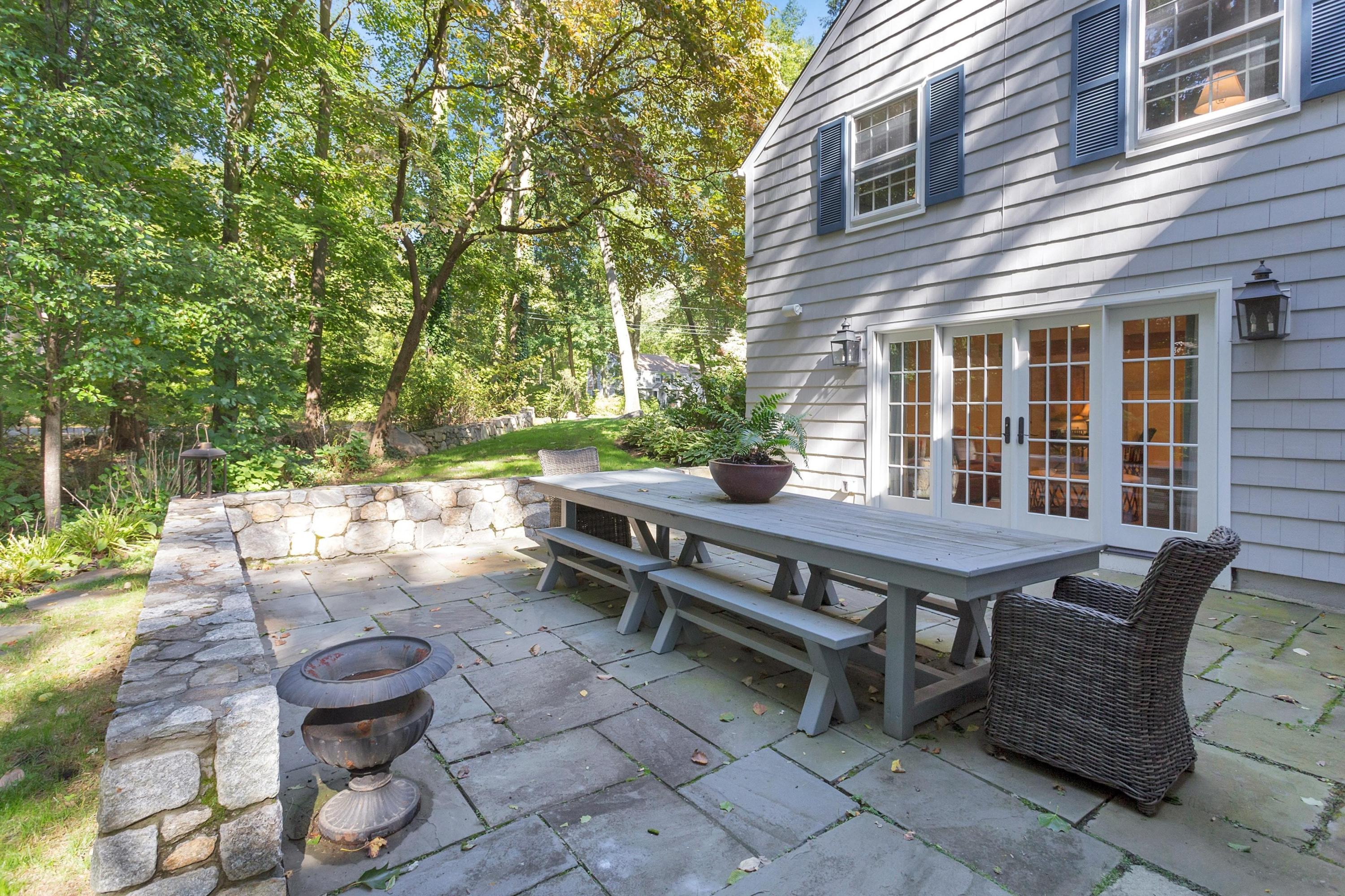 44 Deepwood Road Darien, CT 06820 - Photo 32 of 45 a backyard of a house with barbeque oven table and chairs