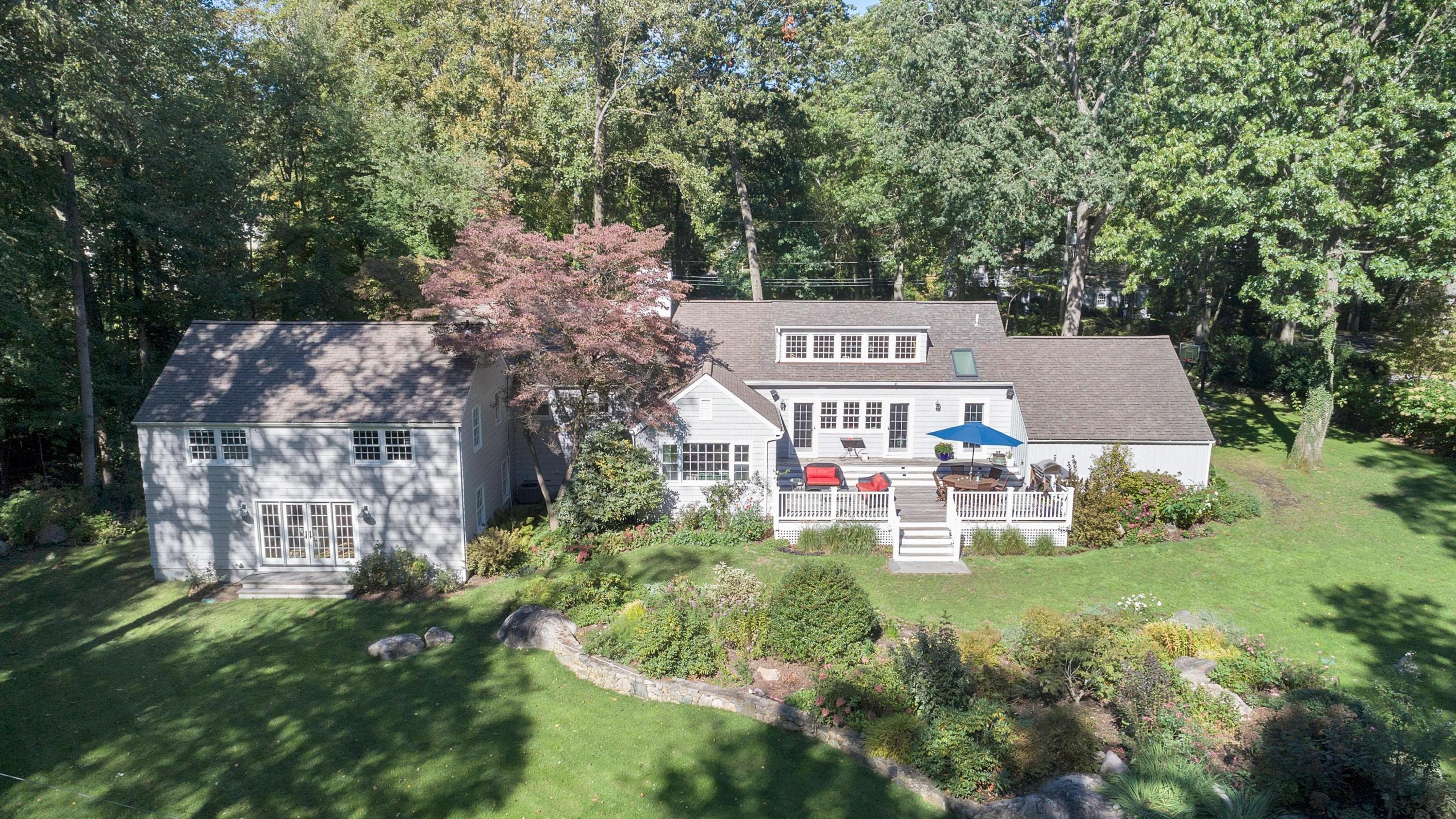 44 Deepwood Road Darien, CT 06820 - Photo 36 of 45 a view of a table and chairs under an umbrella