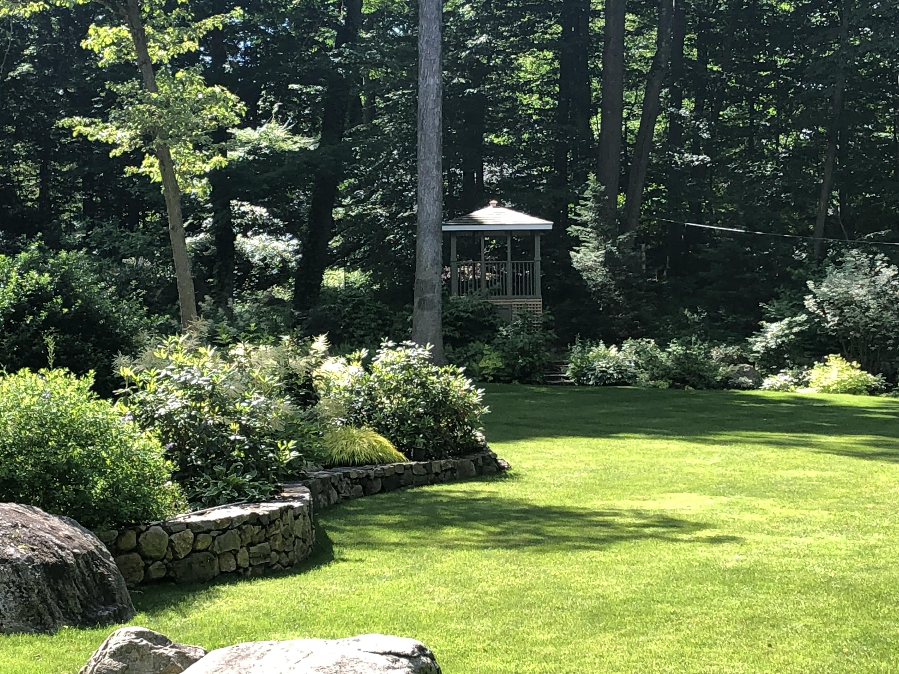 44 Deepwood Road Darien, CT 06820 - Photo 41 of 45 a front view of a house with a yard and swimming pool