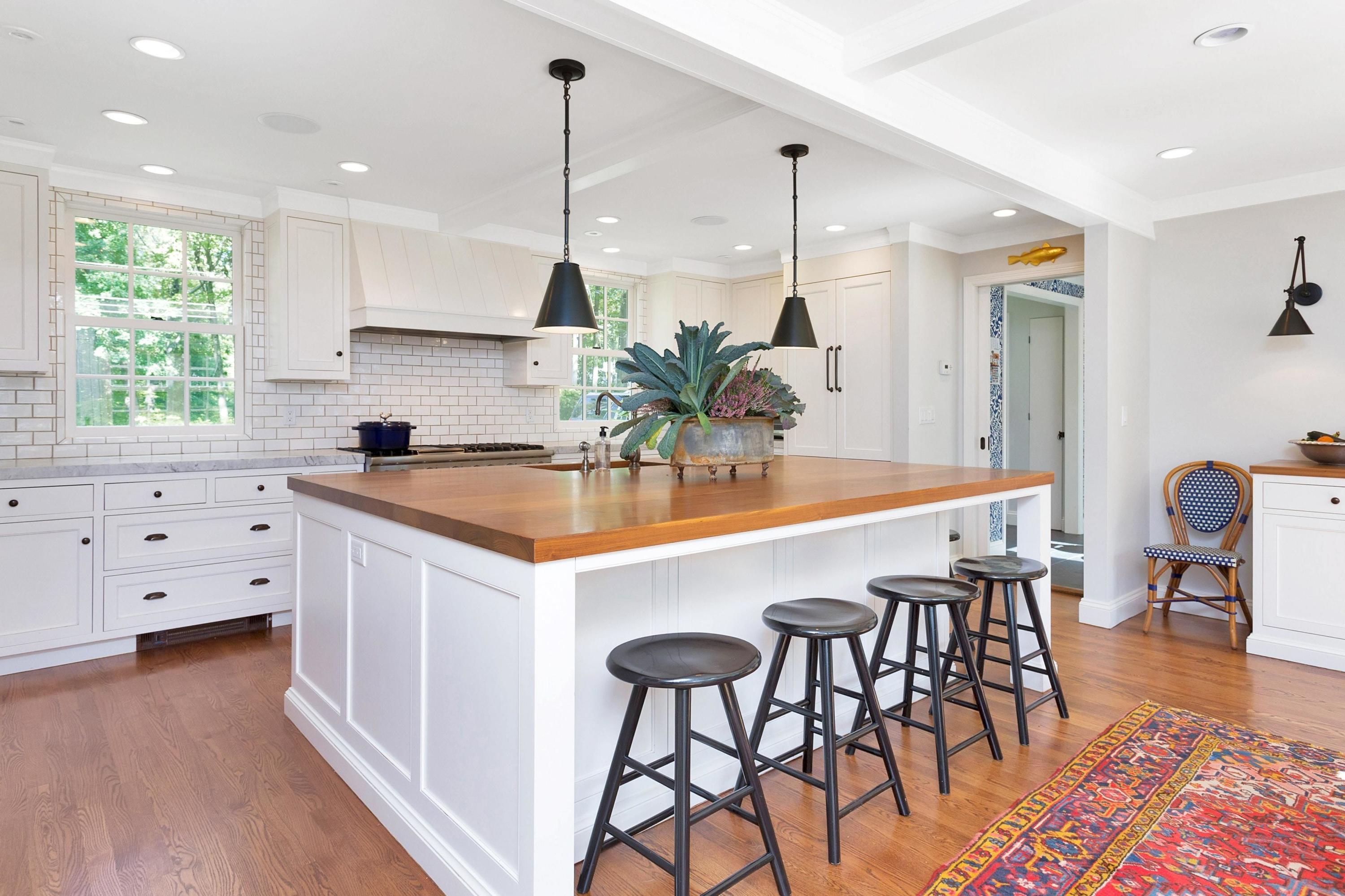 44 Deepwood Road Darien, CT 06820 - Photo 9 of 45 a kitchen with stainless steel appliances kitchen island a table chairs in it and wooden floors