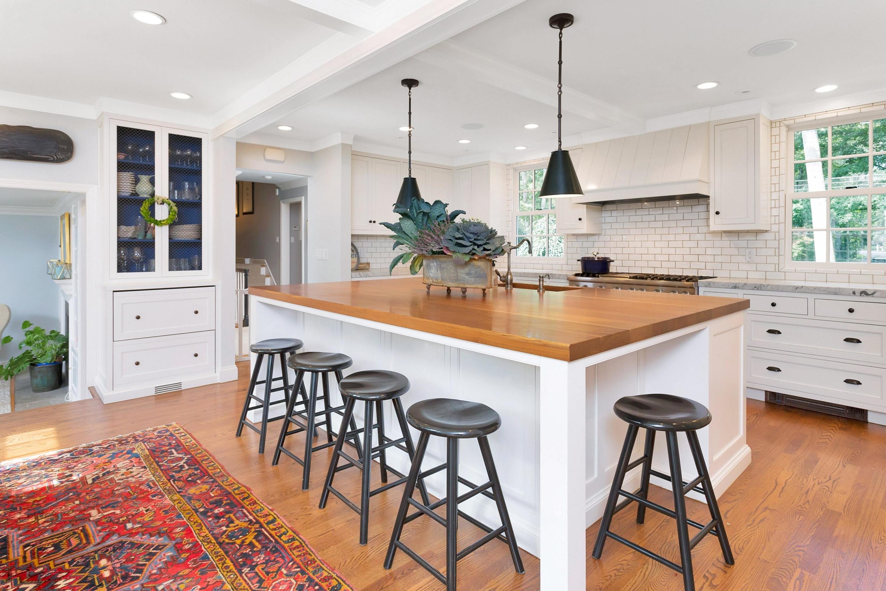 44 Deepwood Road Darien, CT 06820 - Photo 10 of 45 a kitchen with stainless steel appliances granite countertop a stove a sink a oven a dining table and chairs with wooden floor