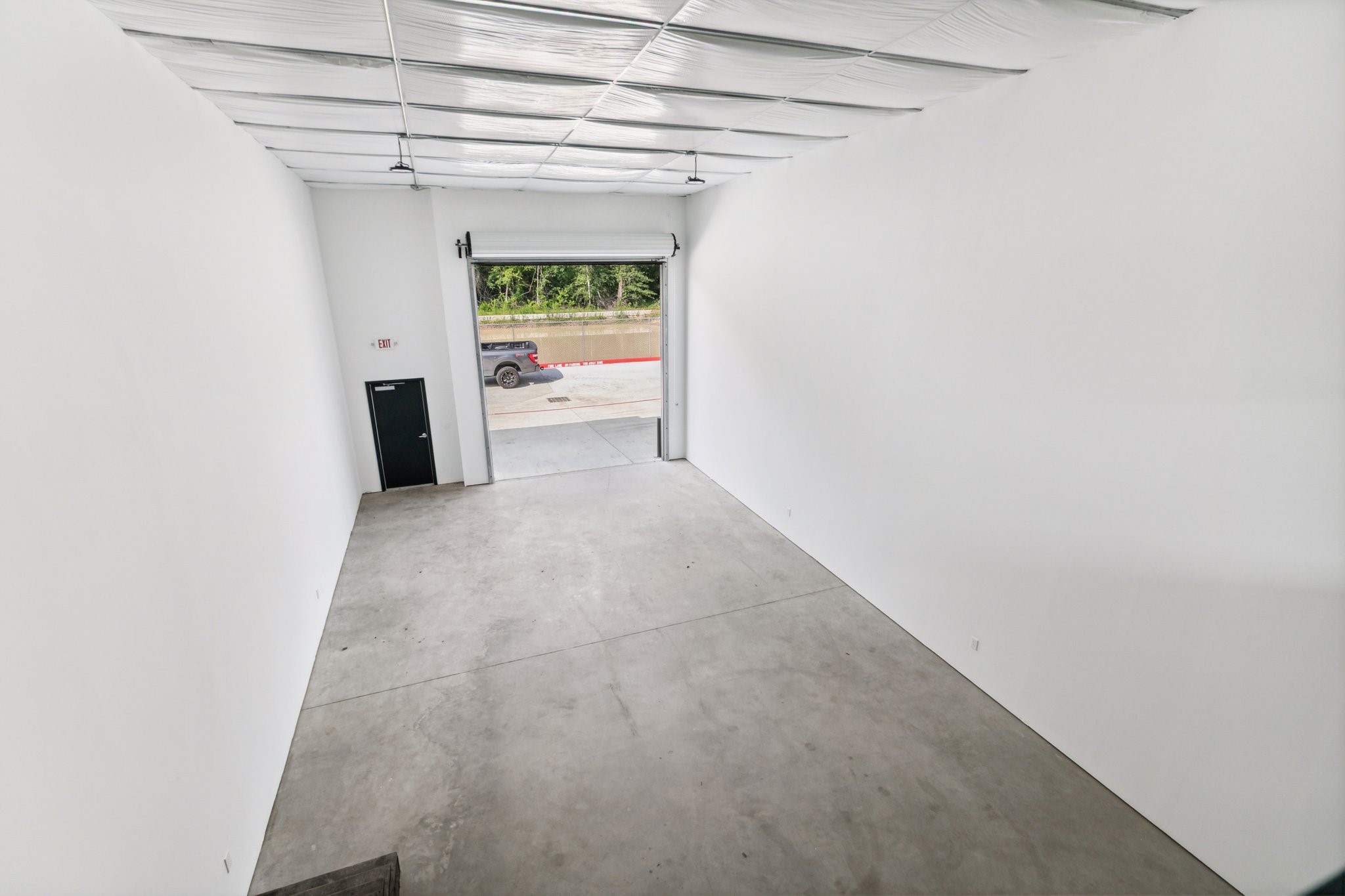 12402 Malcomson Road Houston, TX 77070 - Photo 18 of 50 a view of a hallway with a white cabinet and a refrigerator