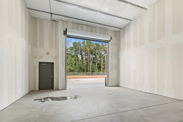 a view of a hallway with wooden door and seating space