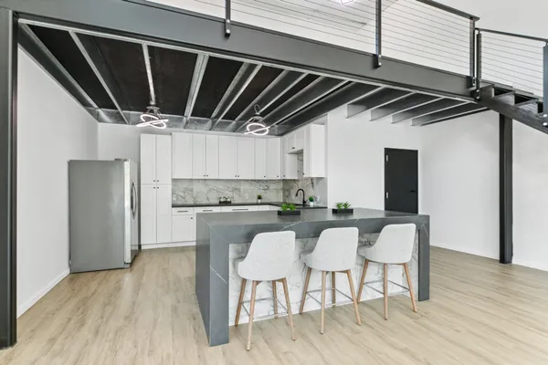 a kitchen with a sink cabinets and wooden floor