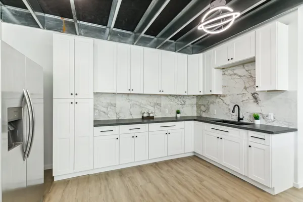 a kitchen with stainless steel appliances granite countertop a sink and cabinets