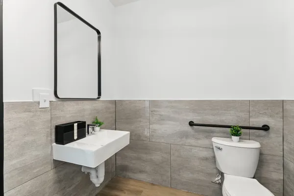 a bathroom with a toilet a sink and a mirror