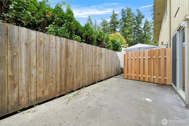 a view of a backyard with wooden fence