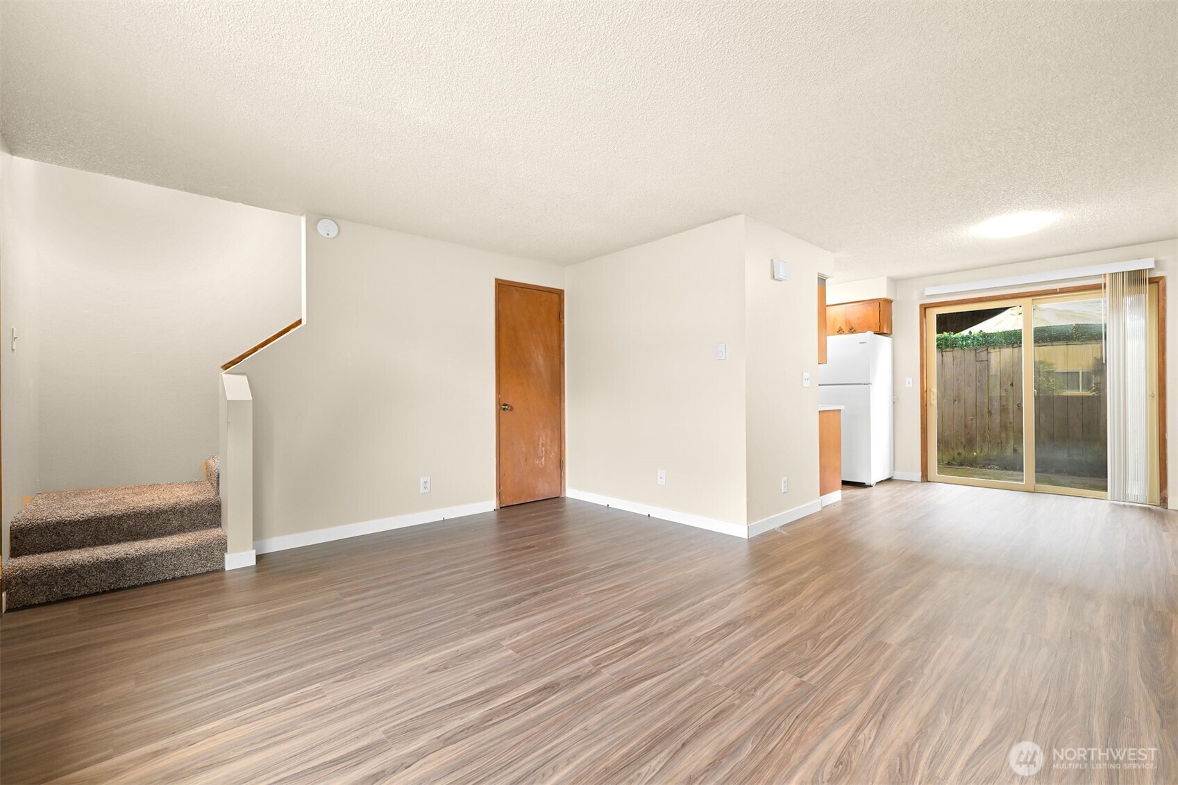 3330 Northwest Avenue Bellingham, WA 98225 - Photo 16 of 24 a view of an empty room with wooden floor and a window