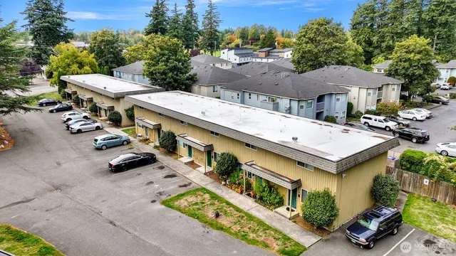 an aerial view of a house with garden space and street view
