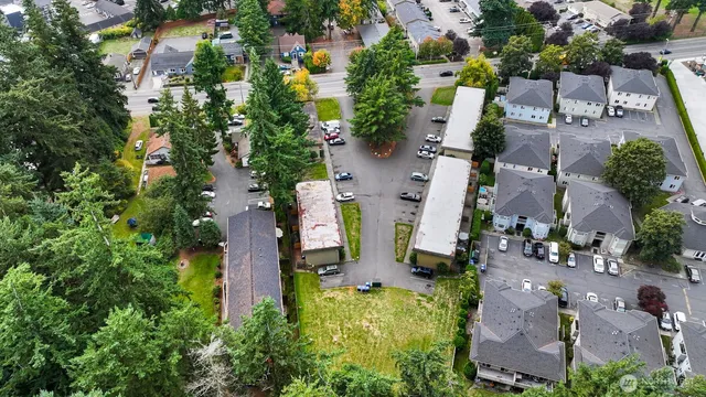 an aerial view of multiple houses with yard