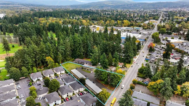 an aerial view of residential houses with outdoor space
