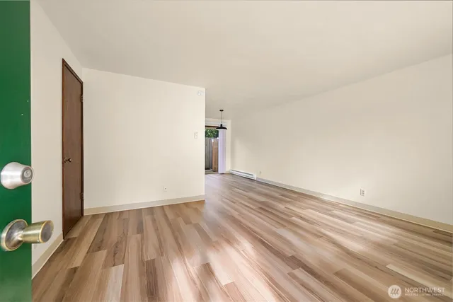a view of a room with wooden floor