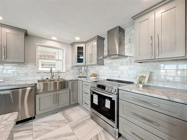 a kitchen with stainless steel appliances kitchen island granite countertop a counter top space a sink and cabinets