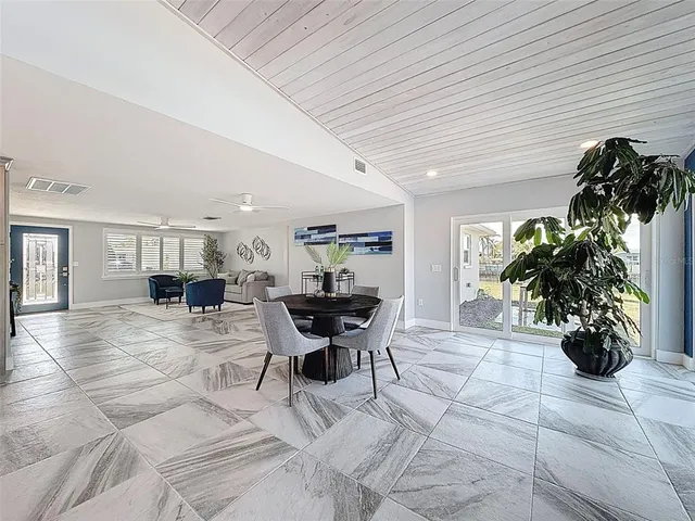 a bedroom with a bed a table and painting on the wall