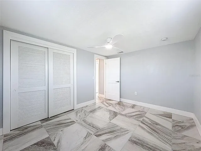 a view of a swimming pool with a bench and lawn chairs