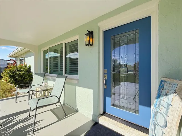 a living room with furniture a window and a flat screen tv