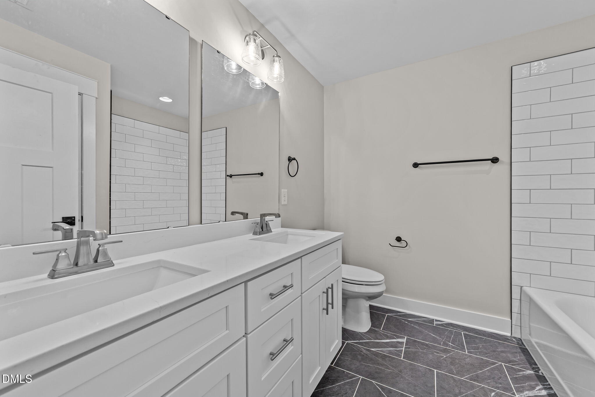 2568 Lassiter Road Four Oaks, NC 27524 - Photo 28 of 50 a bathroom with a double vanity sink toilet and a mirror