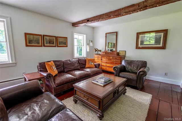 a view of a workspace room with wooden floor and windows