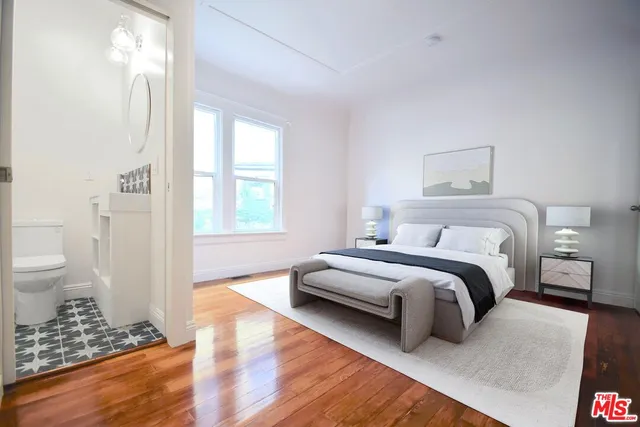 a spacious bedroom with a bed and a window