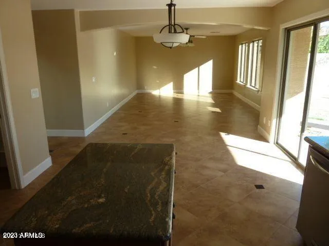 a kitchen with granite countertop a stove and cabinets