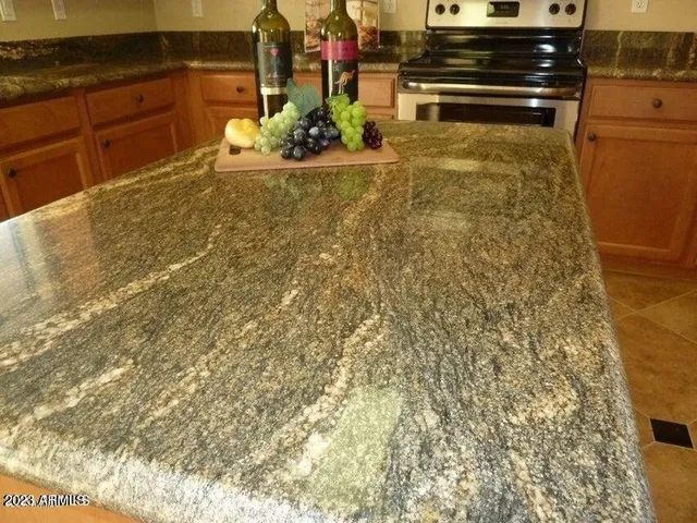a kitchen with granite countertop sink and cabinets