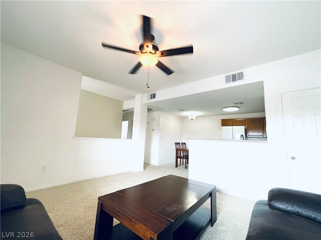 7701 West Robindale Road, Unit 206 Las Vegas, NV 89113 - Photo 6 of 30 Plush wall-to-wall carpeting and an open concept layout define this comfortable living space.