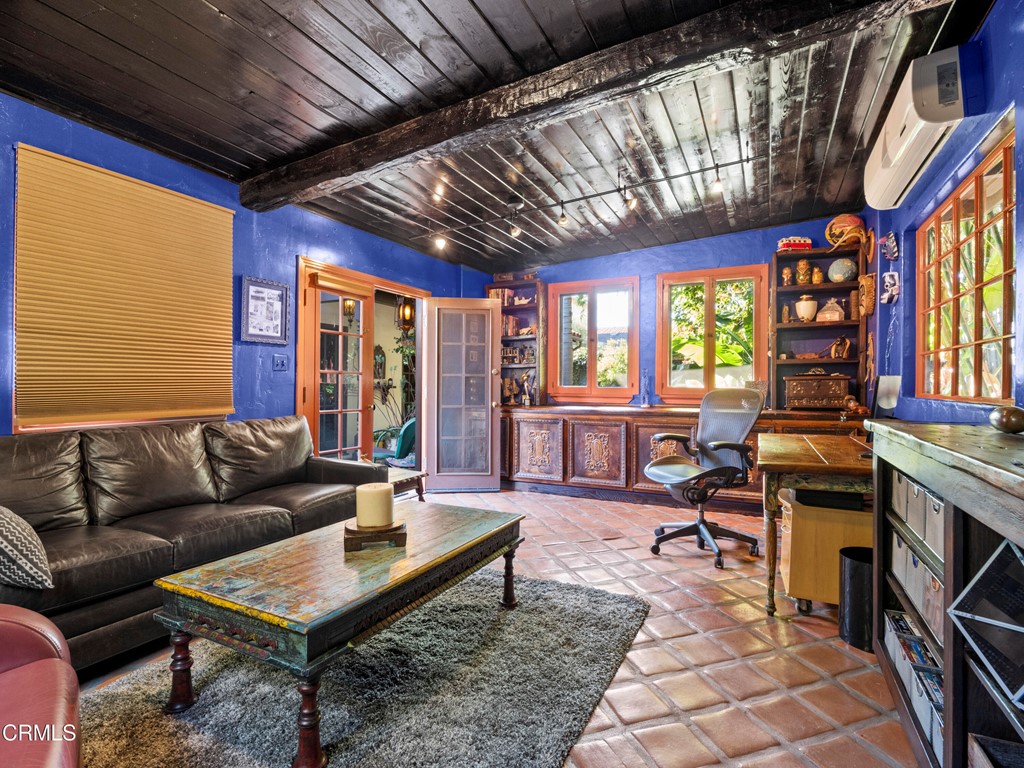 1505 Carroll Drive Altadena, CA 91001 - Photo 20 of 40 a living room with furniture a flat screen tv and a floor to ceiling window