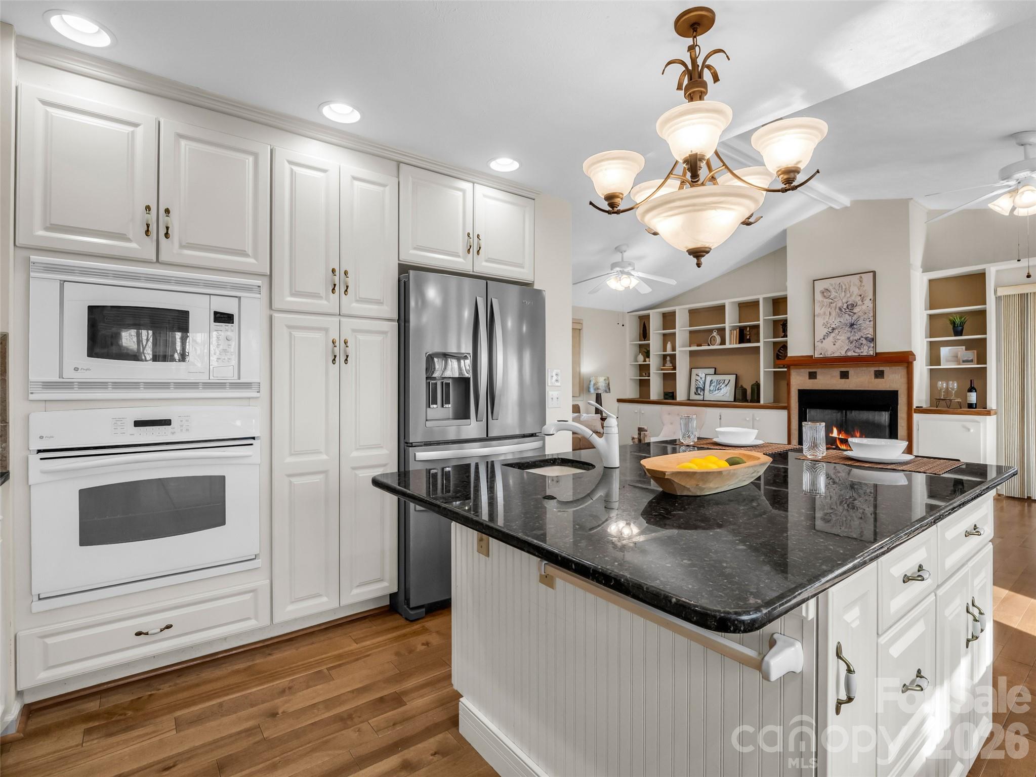 1594 Indian Cave Road Hendersonville, NC 28739 - Photo 18 of 48 a kitchen with stainless steel appliances granite countertop a sink a stove and a wooden floors