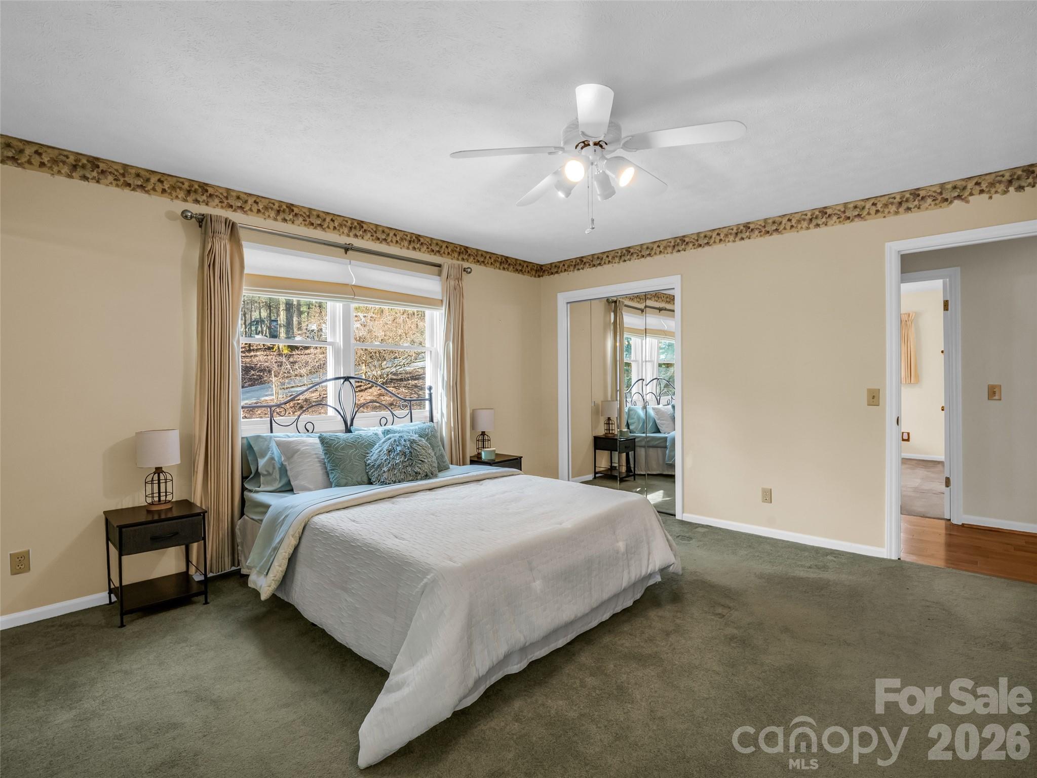 1594 Indian Cave Road Hendersonville, NC 28739 - Photo 22 of 48 a bedroom with a large bed and a window