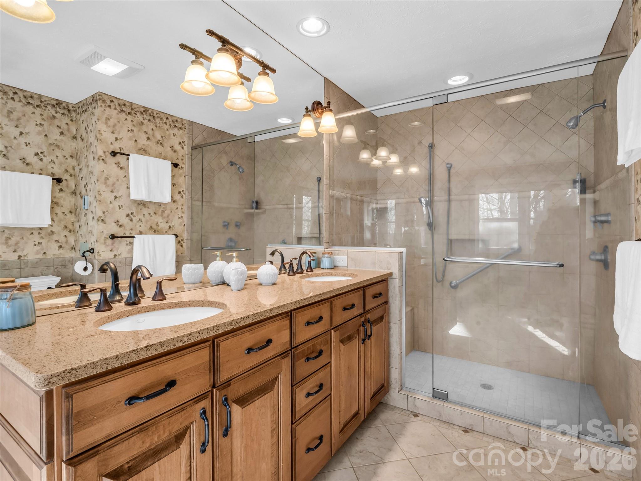 1594 Indian Cave Road Hendersonville, NC 28739 - Photo 27 of 48 a bathroom with a double vanity sink mirror and shower