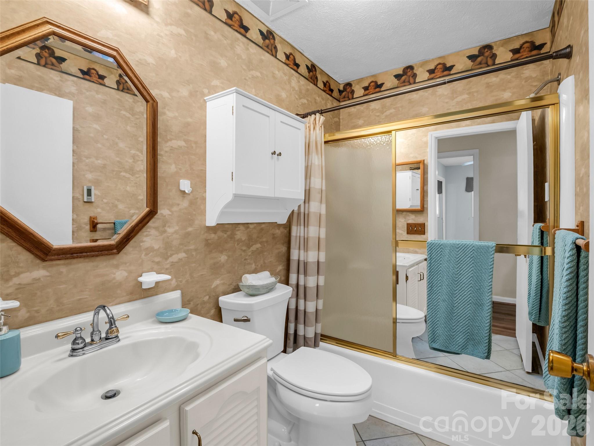 1594 Indian Cave Road Hendersonville, NC 28739 - Photo 31 of 48 a bathroom with a sink mirror vanity and toilet