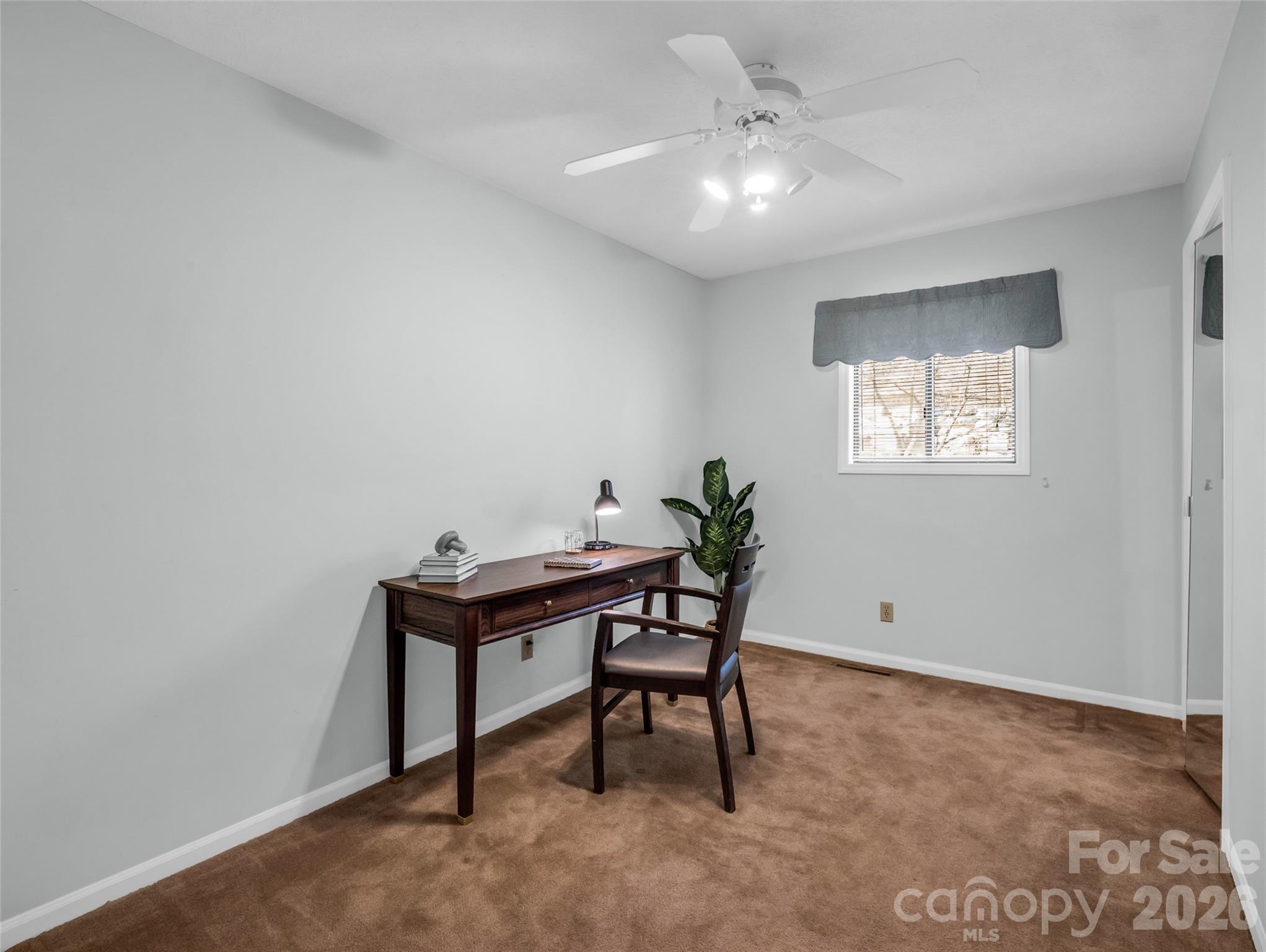 1594 Indian Cave Road Hendersonville, NC 28739 - Photo 32 of 48 a view of a workspace with furniture and a window