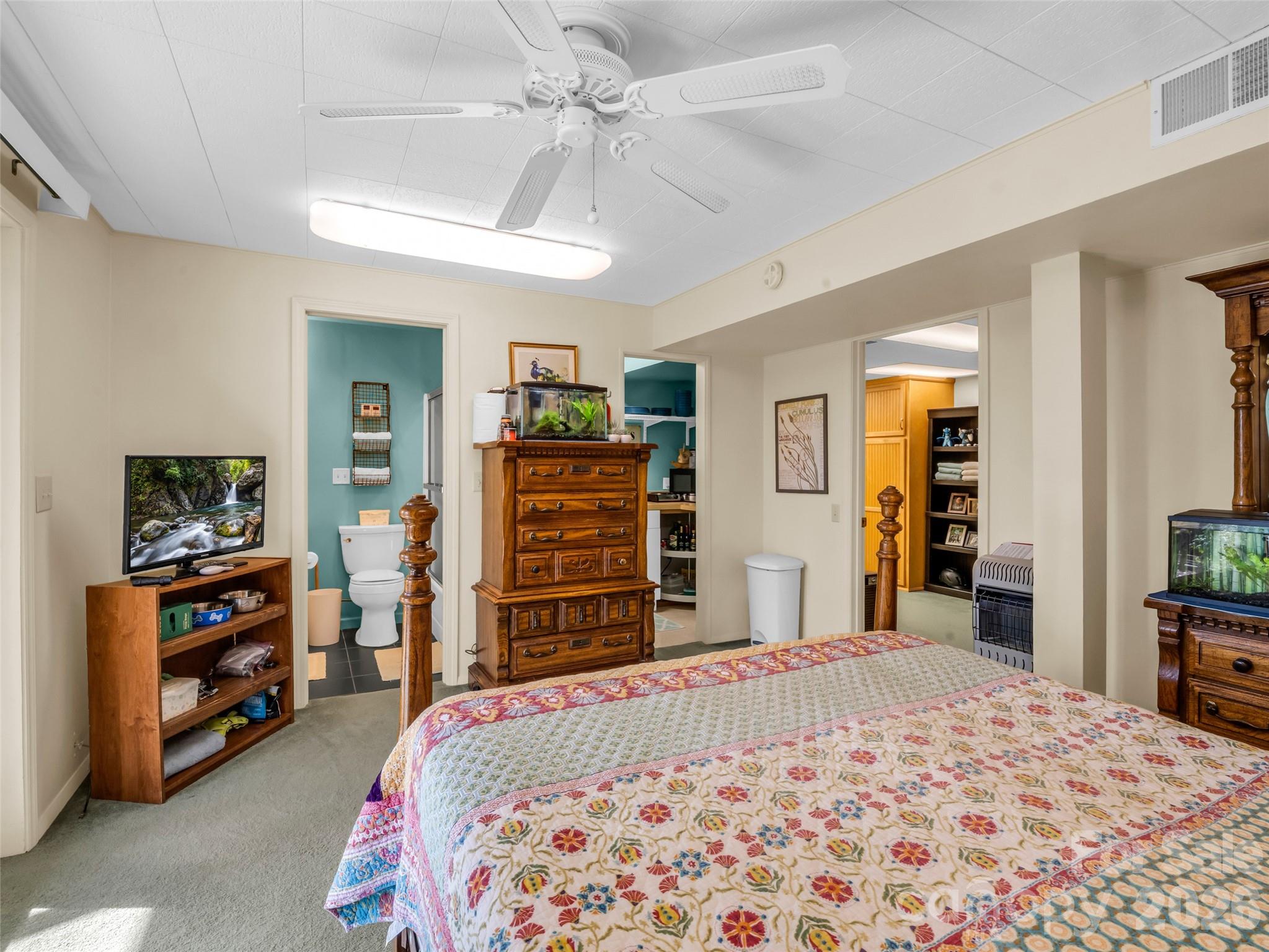 1594 Indian Cave Road Hendersonville, NC 28739 - Photo 38 of 48 a bedroom with a bed and a flat tv screen on dresser