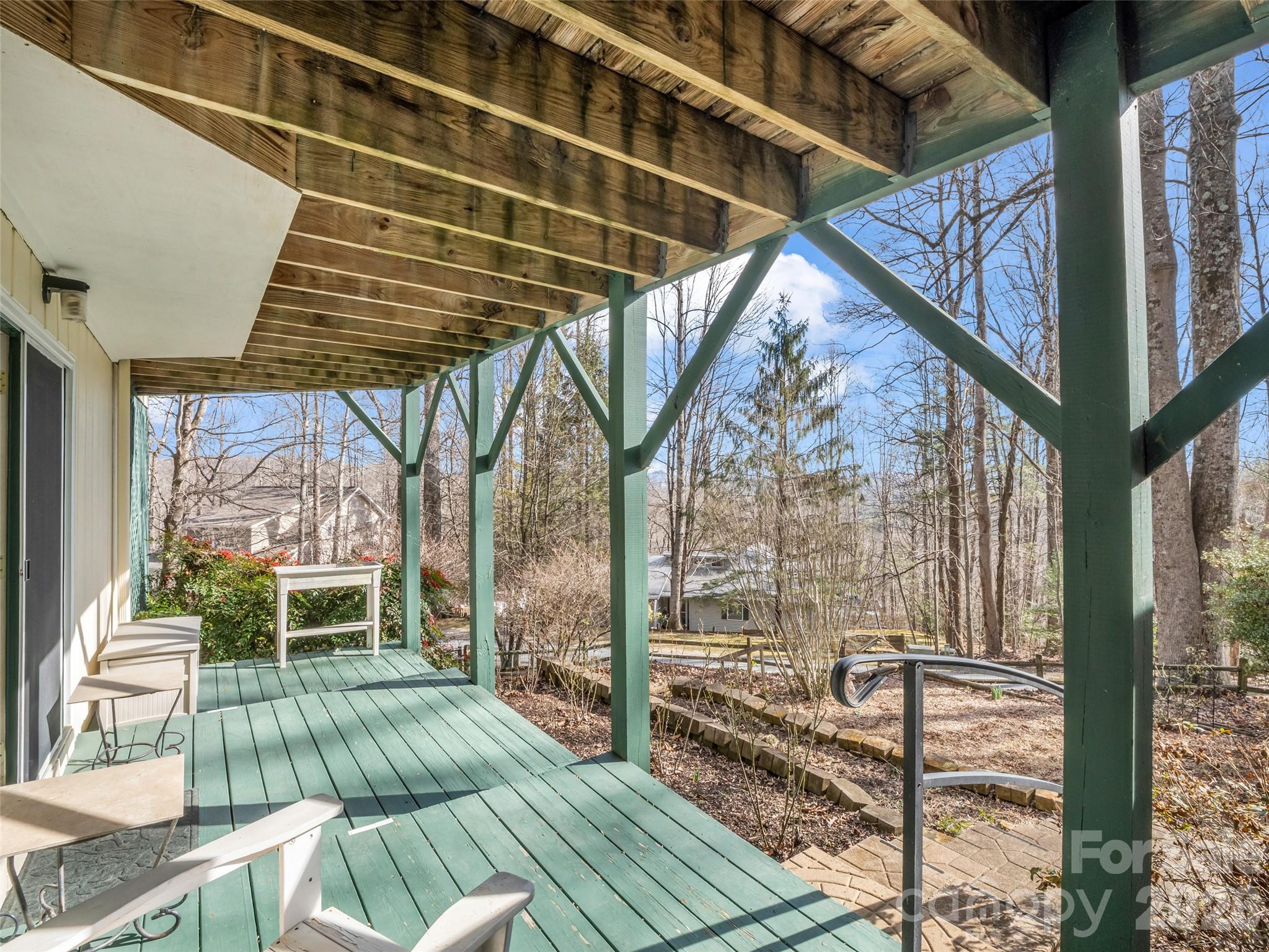 1594 Indian Cave Road Hendersonville, NC 28739 - Photo 41 of 48 a view of a porch with furniture and floor to ceiling window