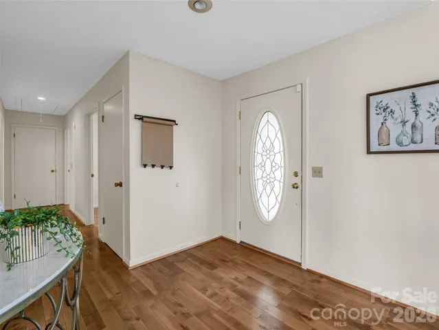 a view of an entryway with wooden floor