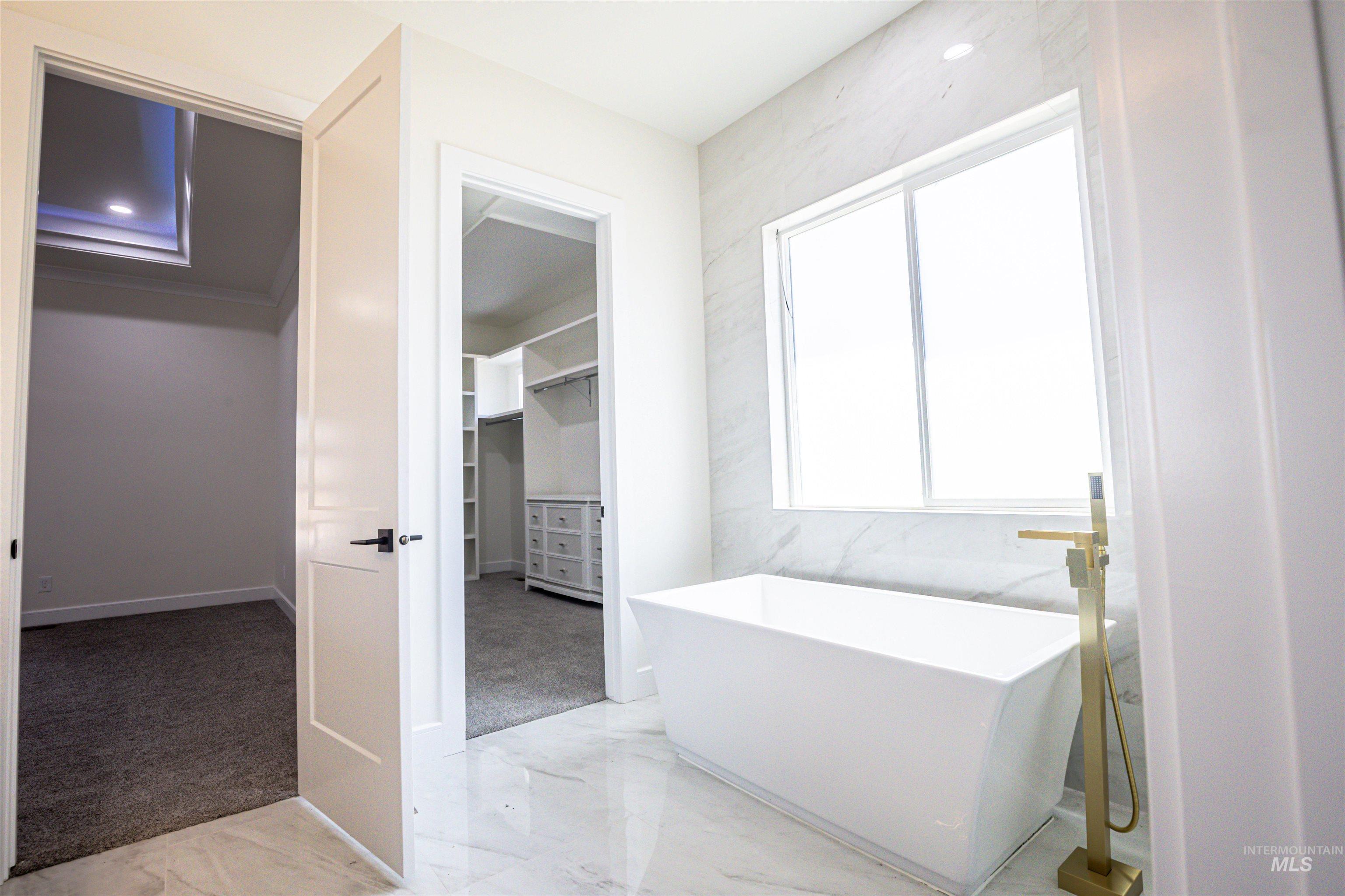 23904 Southview Lane Middleton, ID 83644 - Photo 11 of 29 Freestanding rectangular soaking tub with a floor-mounted brass faucet