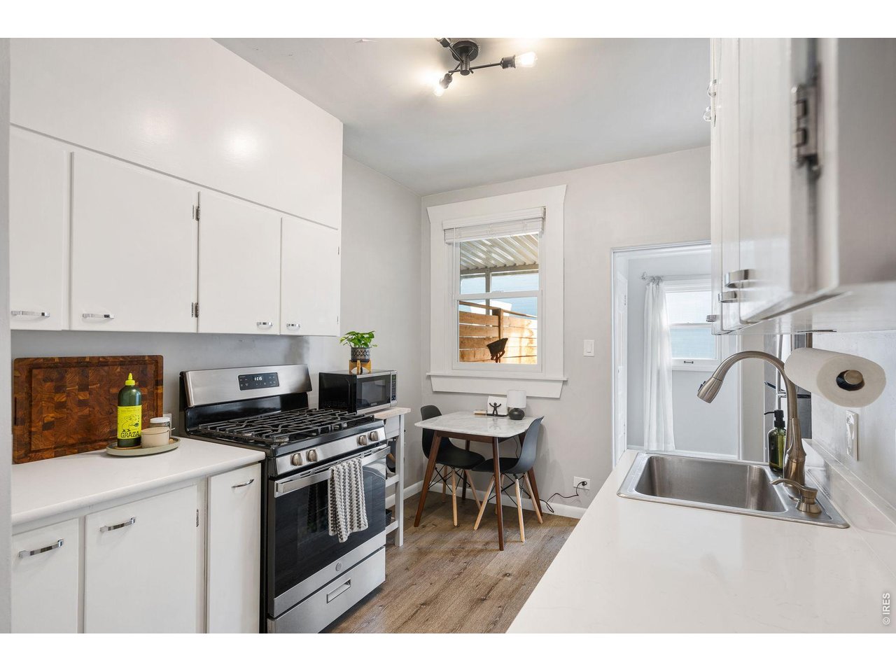 1070 Cook Street Denver, CO 80206 - Photo 12 of 35 a kitchen with granite countertop a sink a stove and cabinets