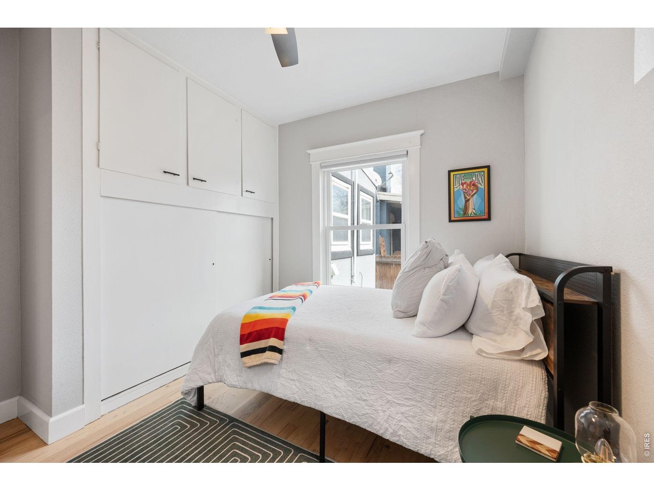 1070 Cook Street Denver, CO 80206 - Photo 13 of 35 a bedroom with a bed and a window