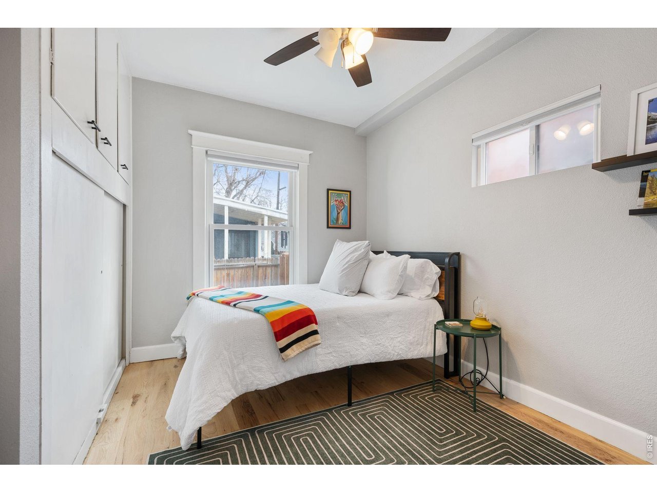 1070 Cook Street Denver, CO 80206 - Photo 14 of 35 a bedroom with a bed and a window