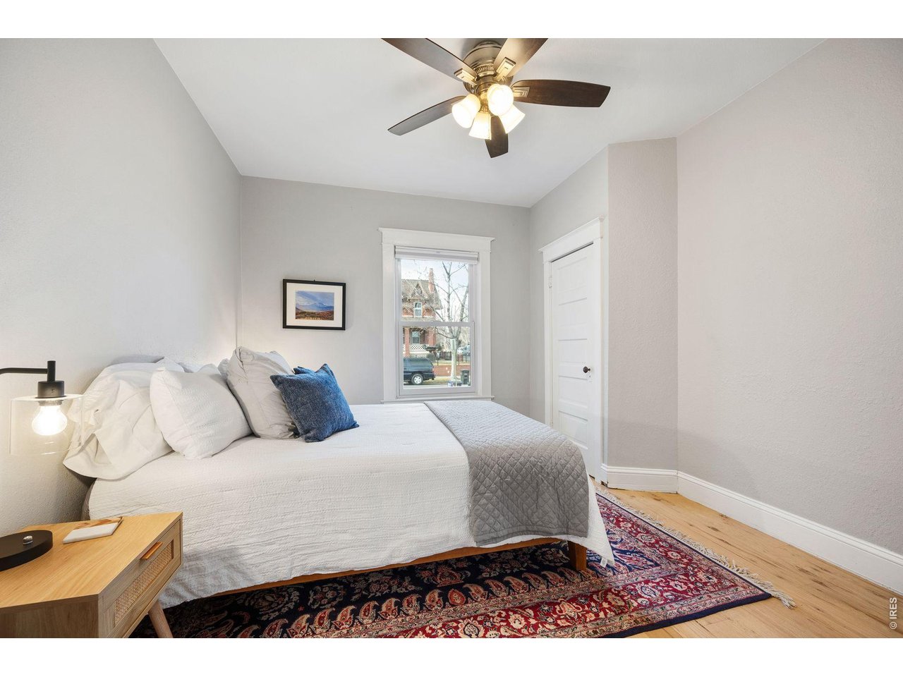 1070 Cook Street Denver, CO 80206 - Photo 15 of 35 a bedroom with a large bed and a chandelier