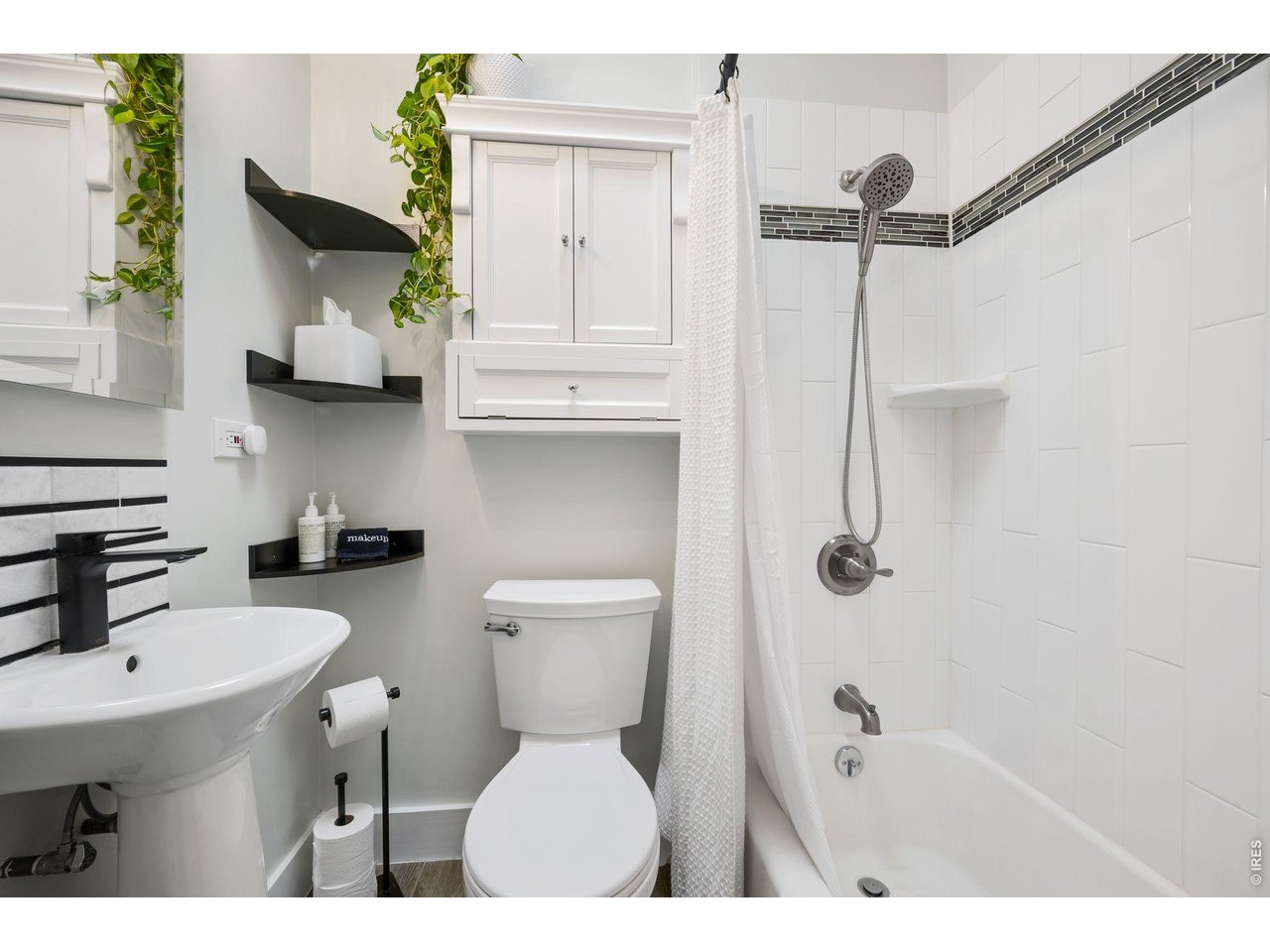 1070 Cook Street Denver, CO 80206 - Photo 17 of 35 a bathroom with a sink toilet and shower