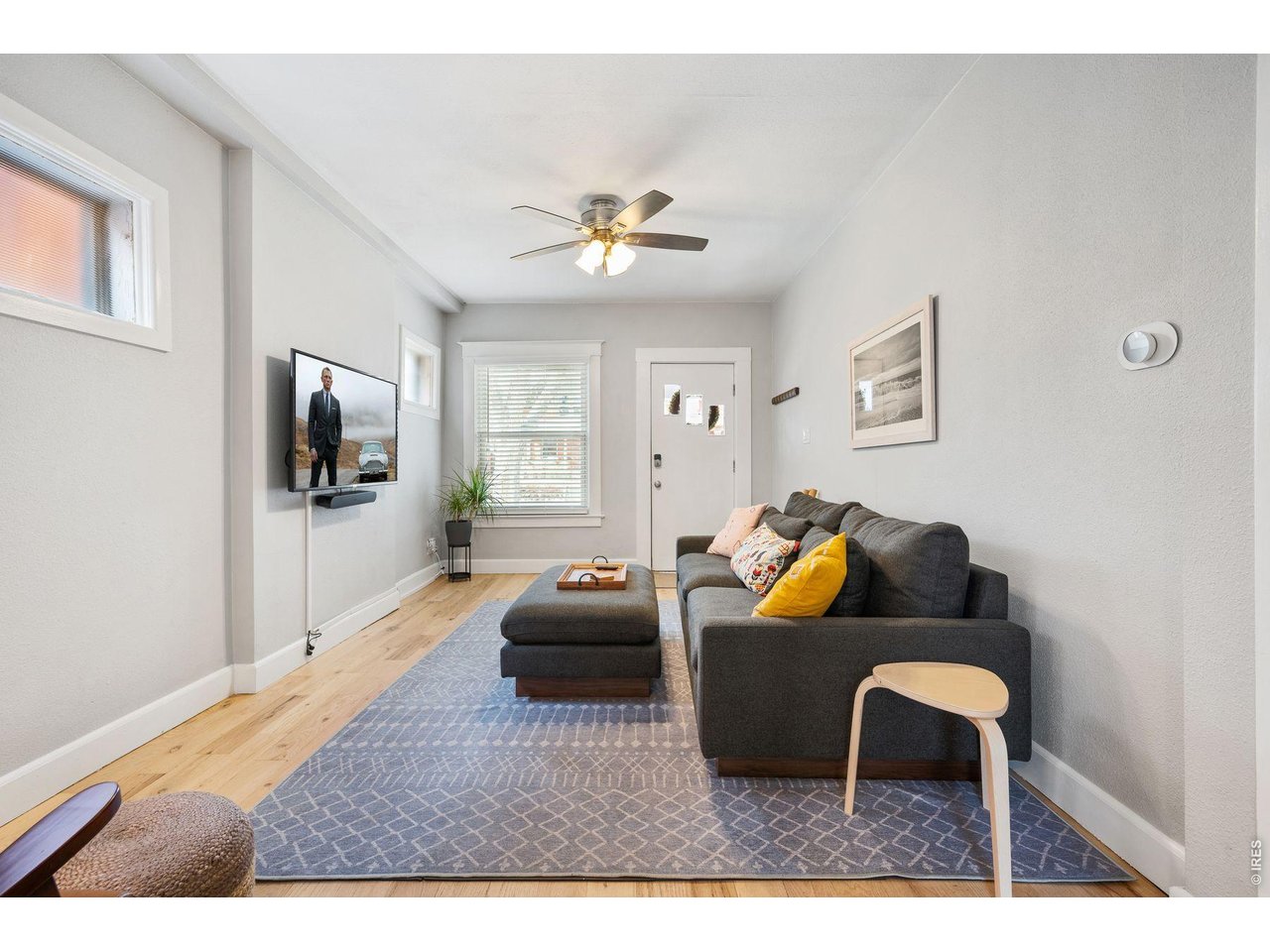 1070 Cook Street Denver, CO 80206 - Photo 3 of 35 a living room with furniture and a flat screen tv