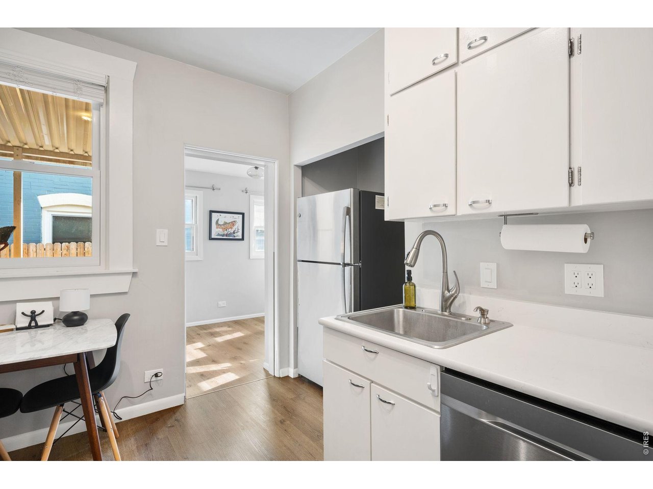1070 Cook Street Denver, CO 80206 - Photo 7 of 35 a kitchen with stainless steel appliances a sink cabinets and wooden floor