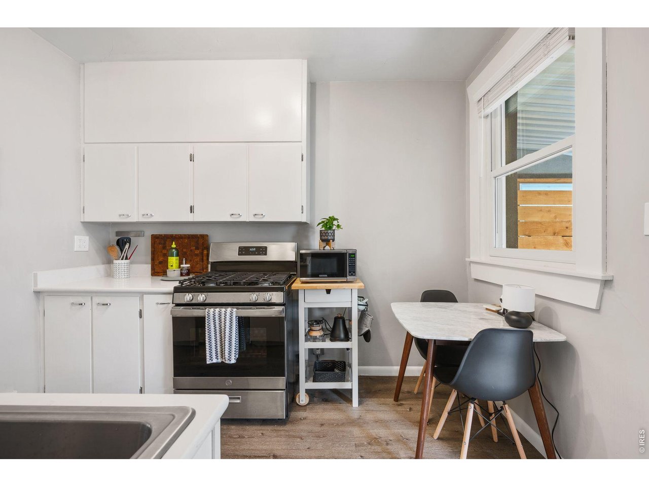 1070 Cook Street Denver, CO 80206 - Photo 8 of 35 a kitchen with a stove a table and chairs