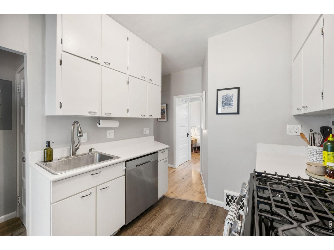 1070 Cook Street Denver, CO 80206 - Photo 10 of 35 a kitchen with a sink stove and white cabinets