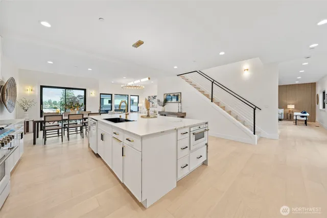 a large white kitchen with a large window