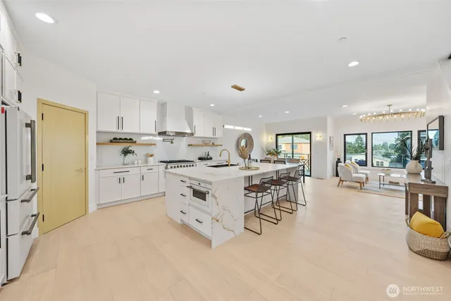 a kitchen with white cabinets and stainless steel appliances