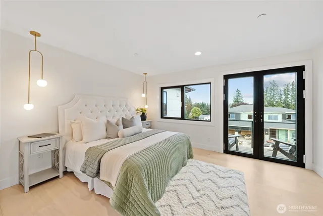 a bedroom with a large bed and a large window